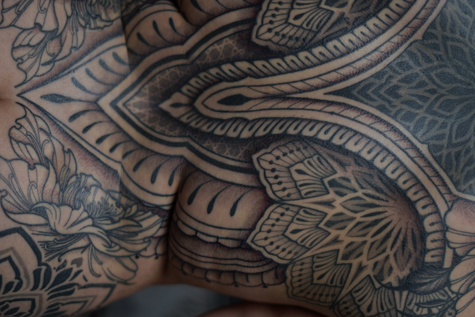 Torso mandala and floral tattoo detail by Steve Sherick