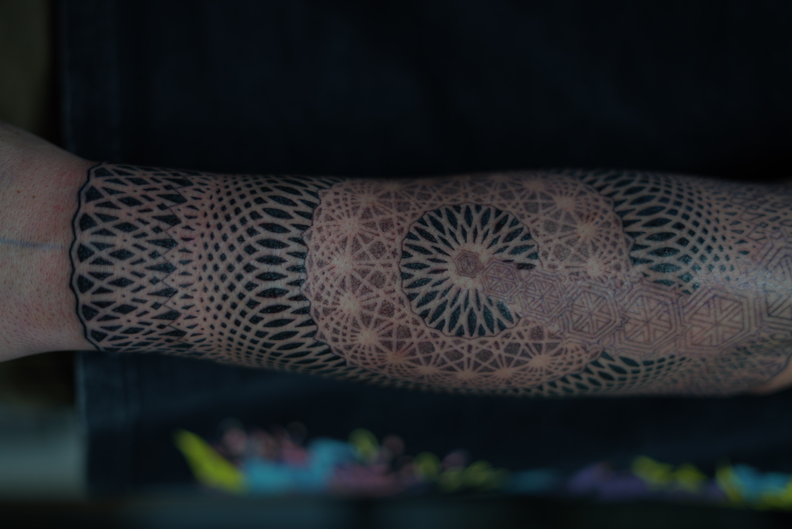 Fine-line sacred geometry forearm band by Steve Sherick