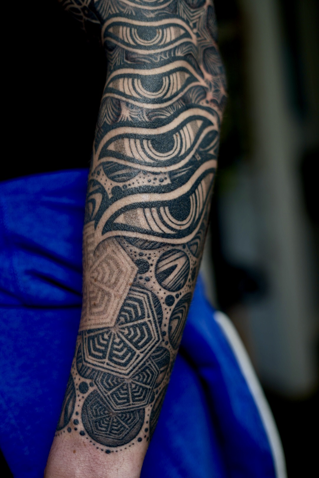 Cosmic sleeve forearm — wave and eye motif blackwork by Steve Sherick