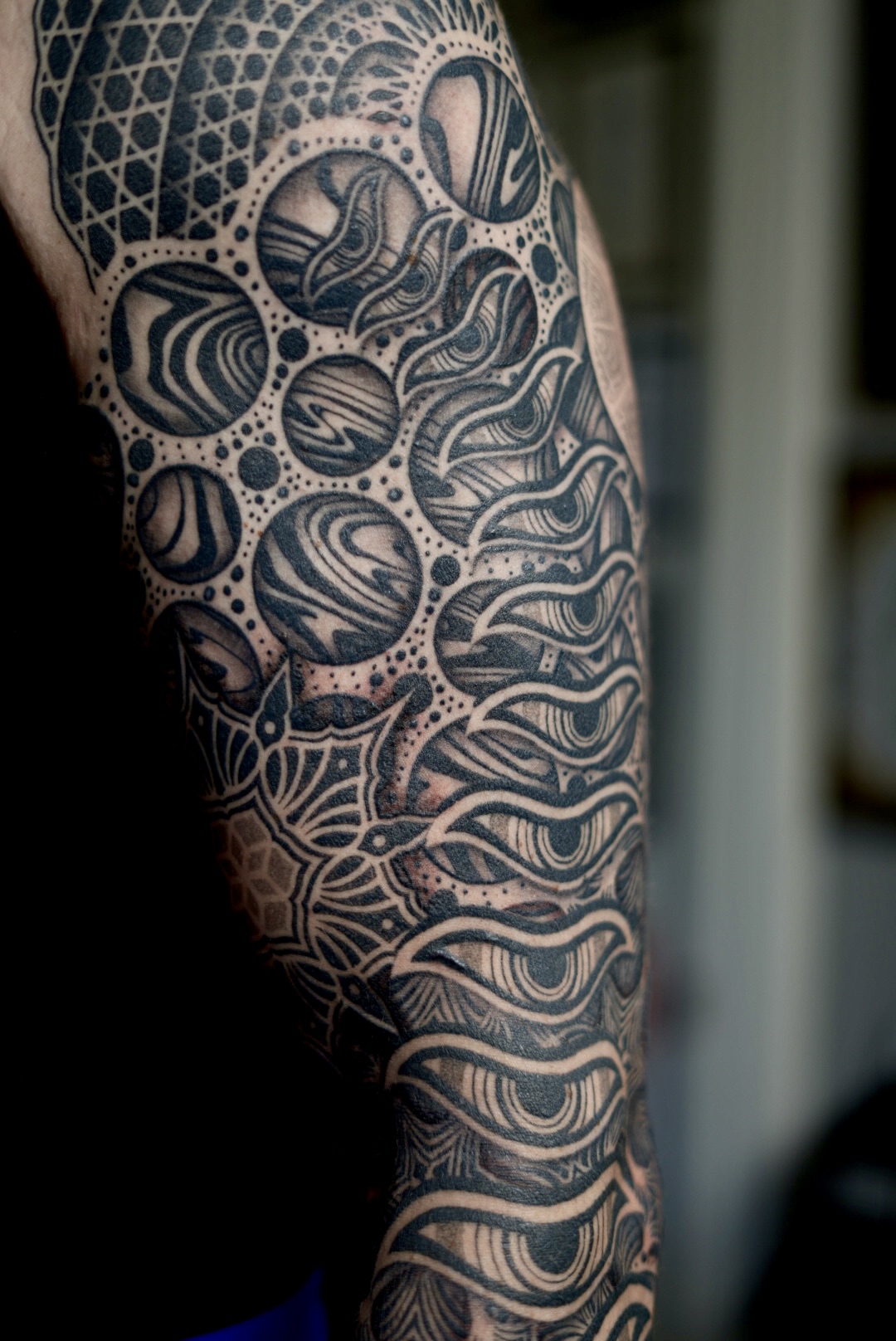Cosmic sleeve upper arm — blackwork detail by Steve Sherick