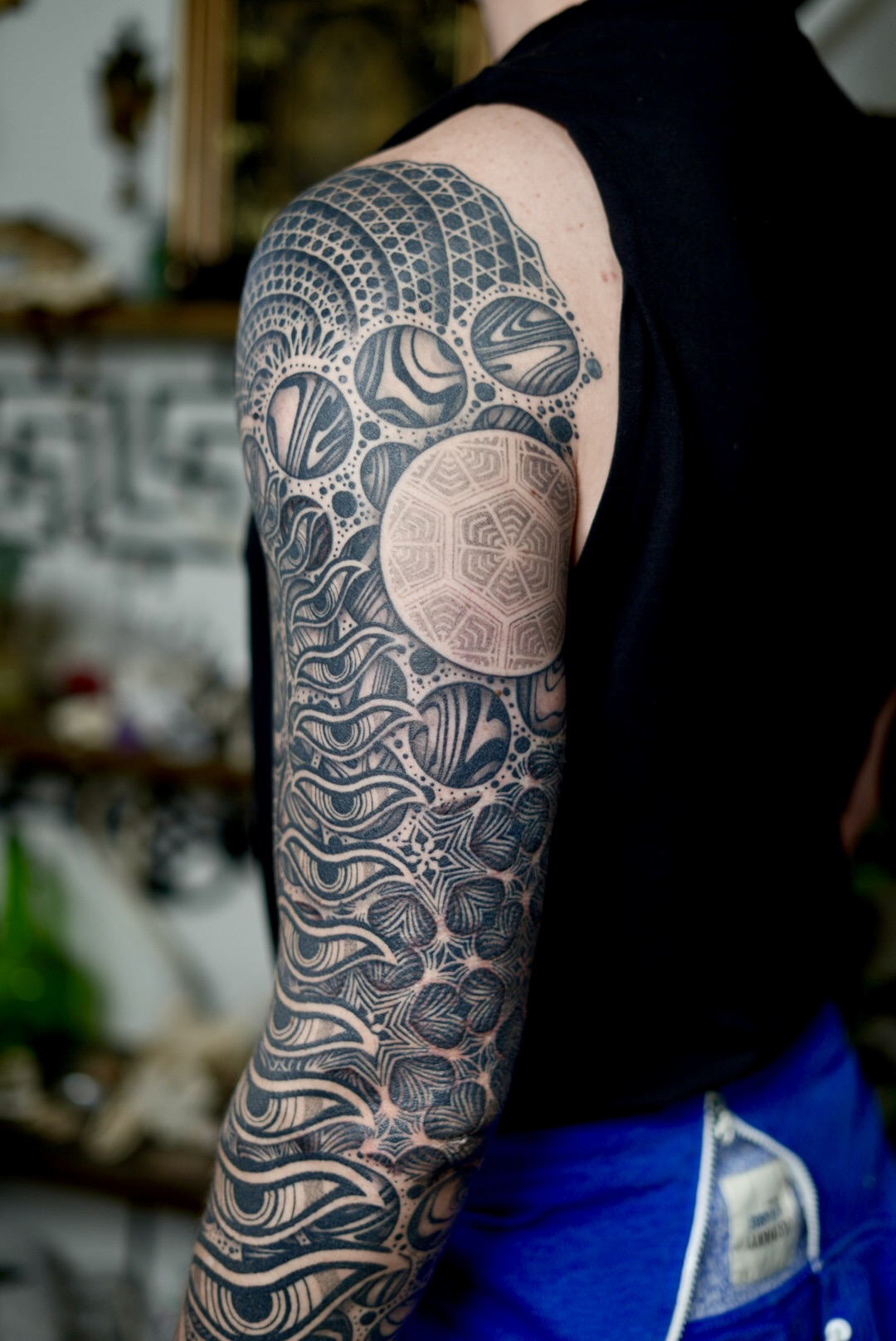 Cosmic sleeve side view — sacred geometry and organic blackwork by Steve Sherick