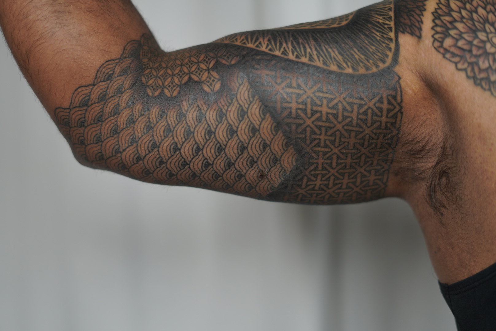 Blackwork neo tribal half sleeve with scales and geometric patterns by Steve Sherick