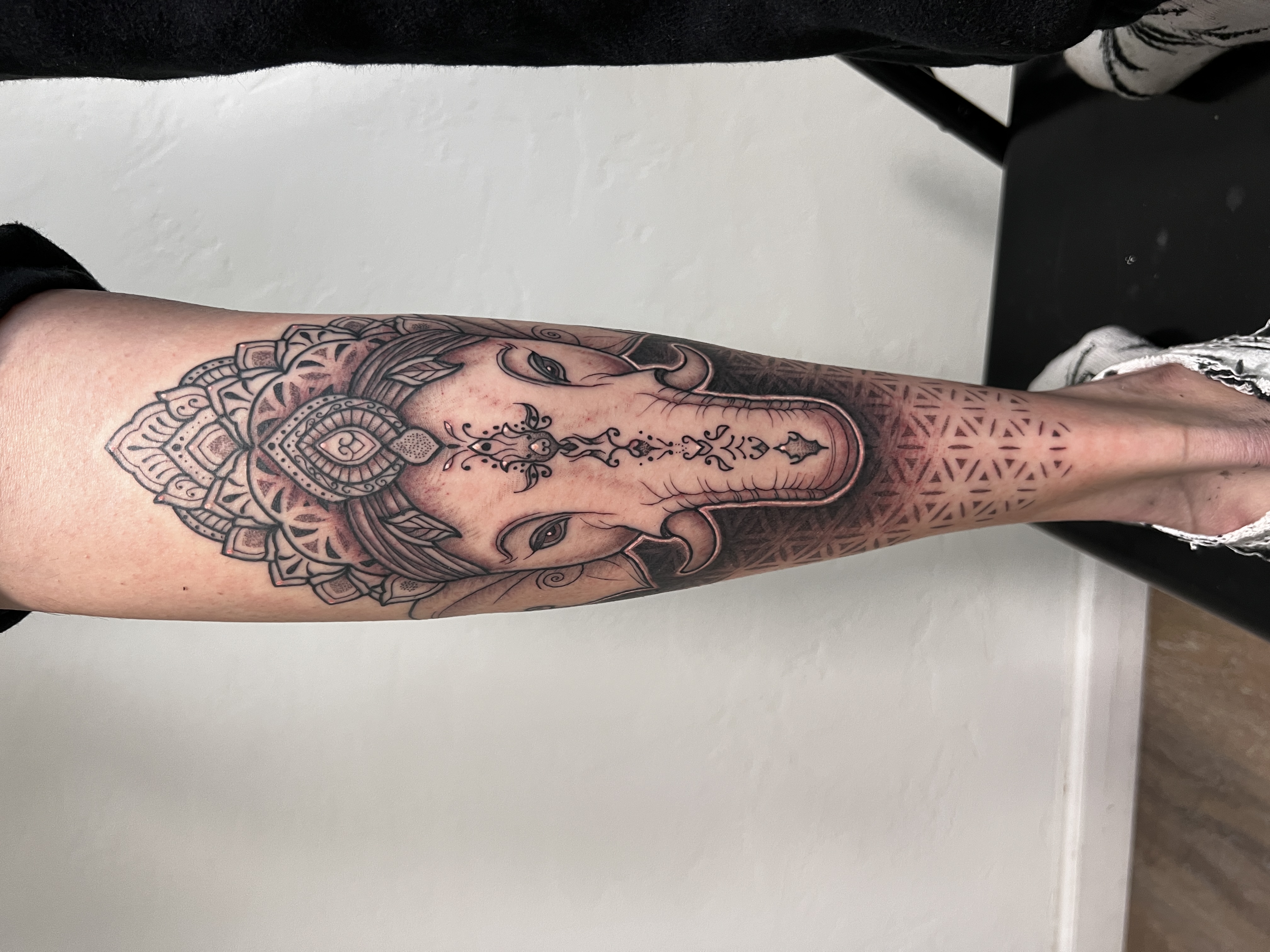 Ganesh blackwork forearm with mandala halo and sacred geometry wrist band by Steve Sherick